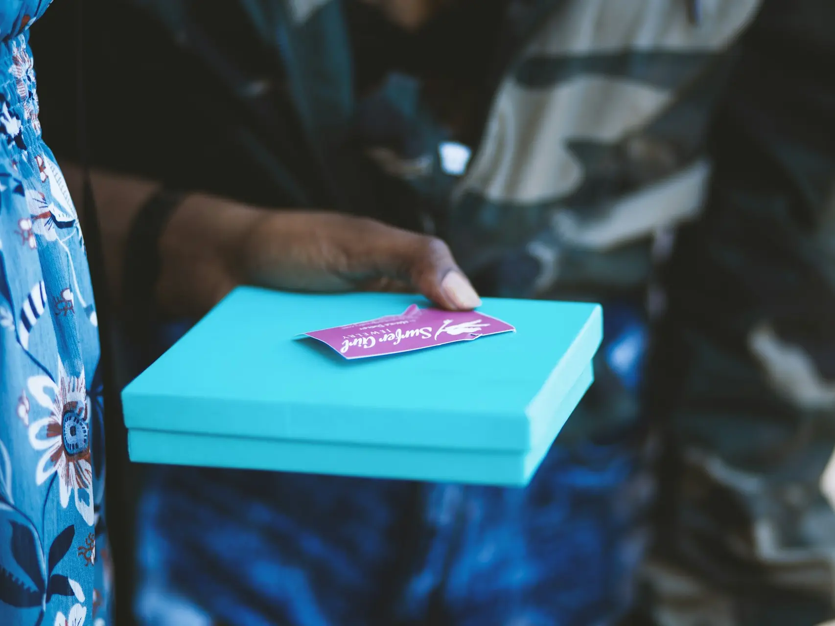 person holding blue box